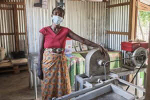 Madame Vola, the president of the Mitambatrasoa Cooperative, stands next to machinery that processes gari. (Photo: The Global FoodBanking Network/iAko Randrianarivelo) 