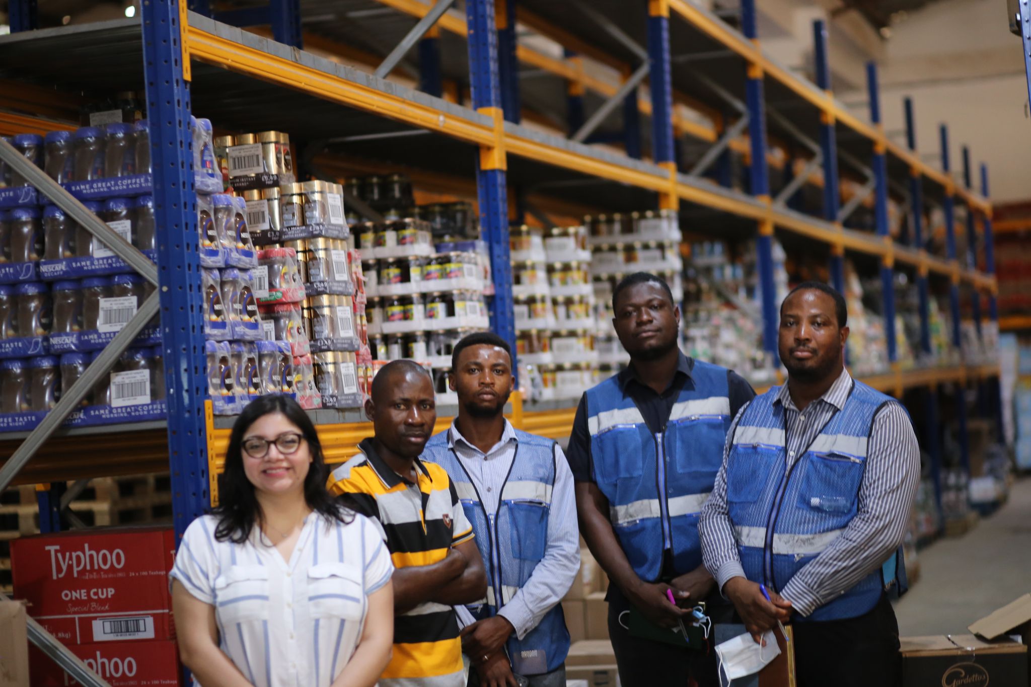 Gaby Kafarhire (left), GFN's Middle East and Africa associate program director, stands with leaders from Food For All Africa in their warehouse in Accra, Ghana. (Photo: Food For All Africa)